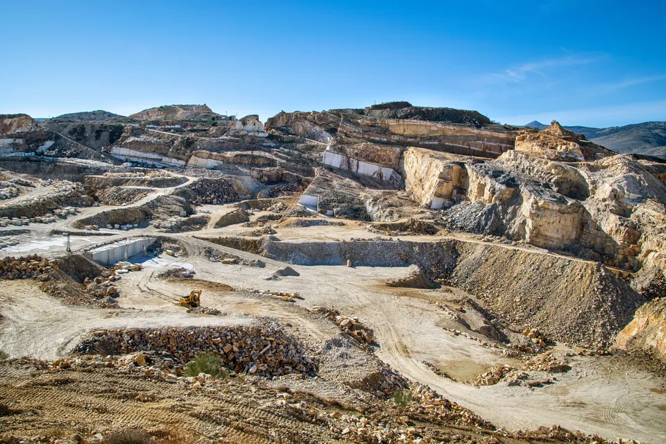 Wide open-pit quarry with heavy machinery