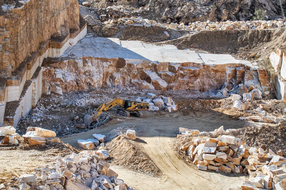 Excavator operating in a quarry